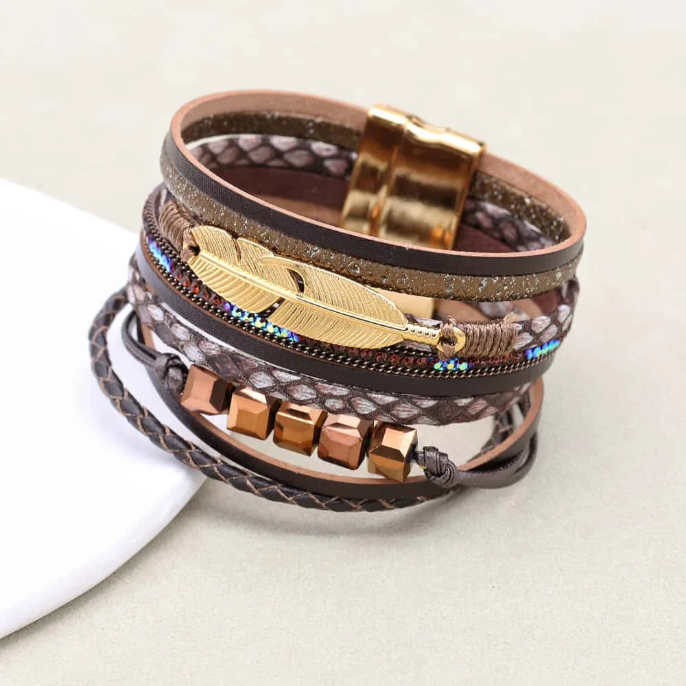 Multistrand bracelet with feathers and beads on a light background