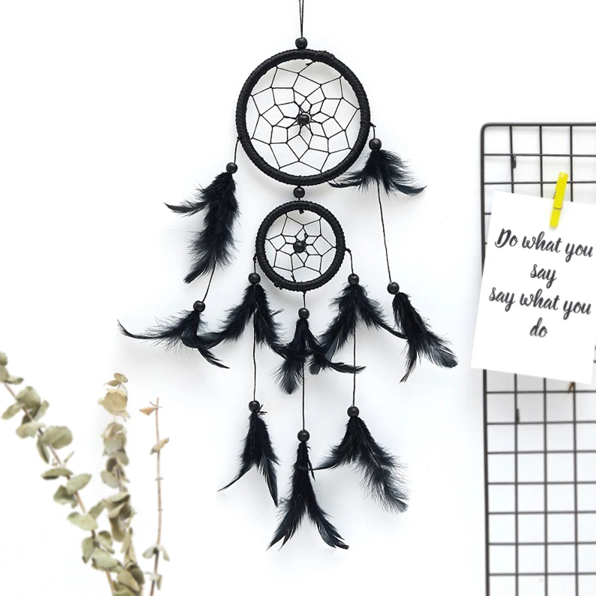Black dreamcatcher with feathers on a white background