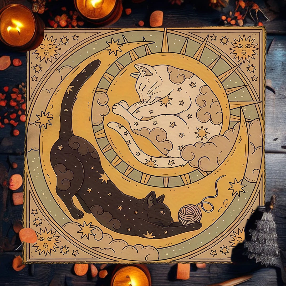 Decorative poster with cats and celestial design on a wooden surface with candles and pumpkins.