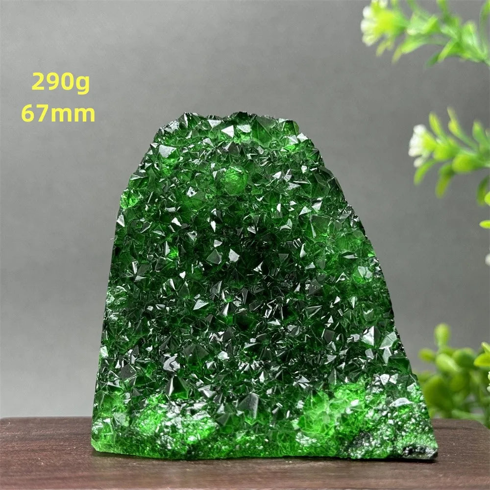 Green crystal rock on a wooden surface with a gray background