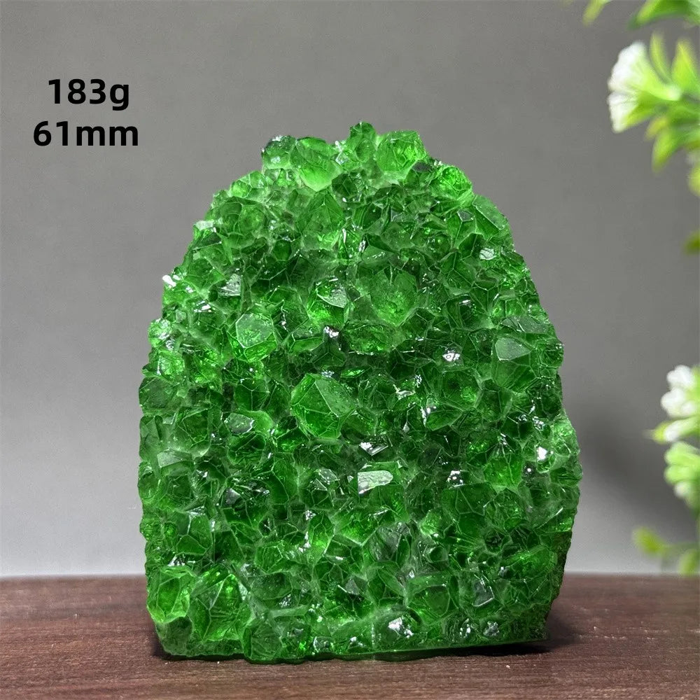 Green crystal rock on a wooden surface with a gray background