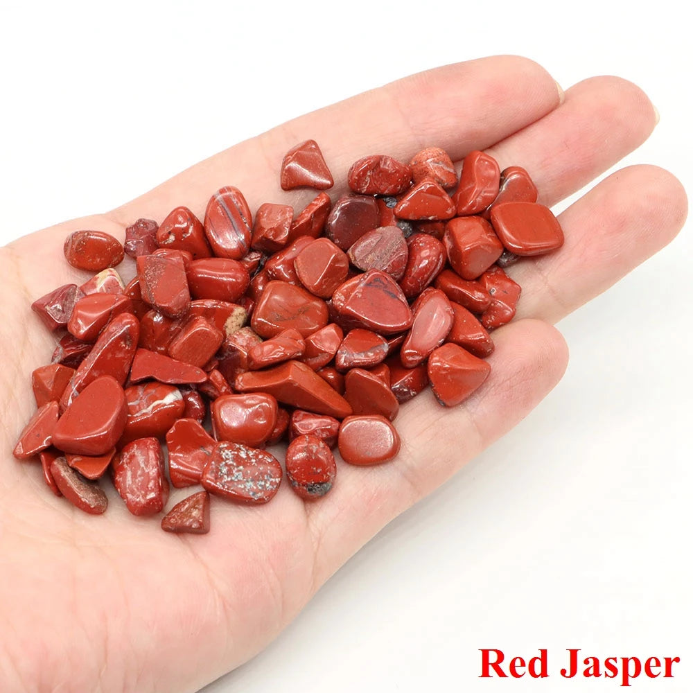 Hand holding red jasper stones with 'Red Jasper' text on a white background