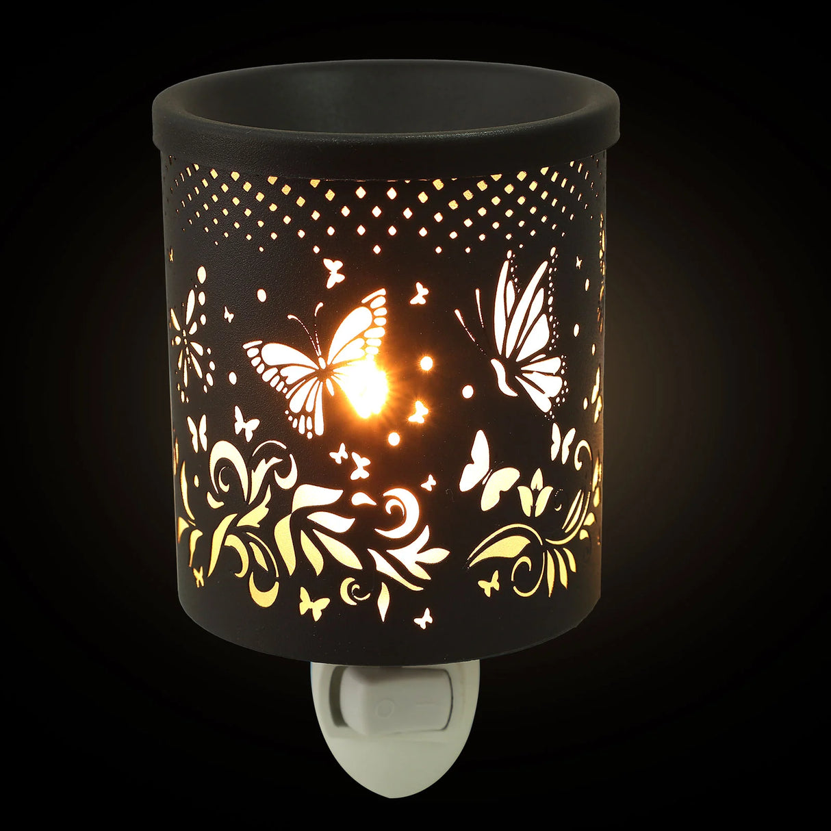 Decorative night light with butterfly and floral patterns on a black background