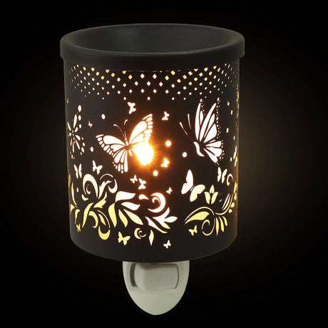 Decorative night light with butterfly and floral patterns on a black background