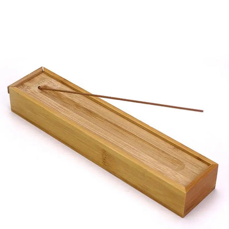 Bamboo incense box with two incense sticks on a white background