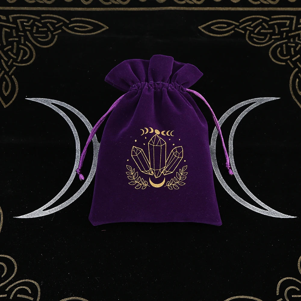 Purple drawstring bag with crystal design on a black background with moon symbols
