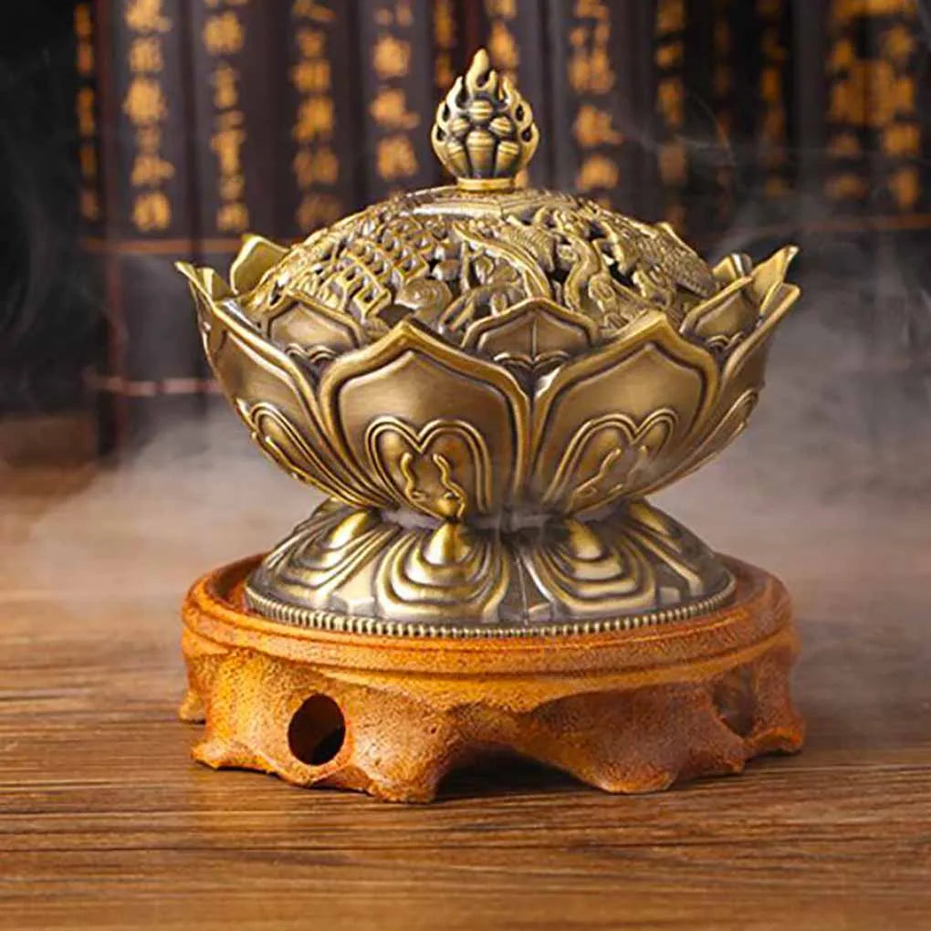 Decorative incense burner with intricate design on a wooden stand, surrounded by smoke.