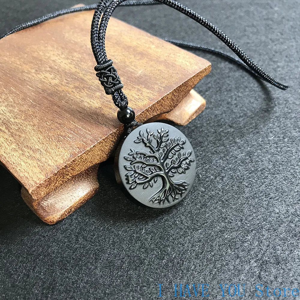Necklace with a tree of life pendant on a dark surface