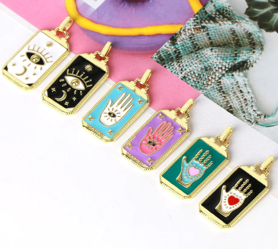 Colorful pendant collection with gold accents on a white surface, with a pink background and 'Cisia Jewelry' branding.