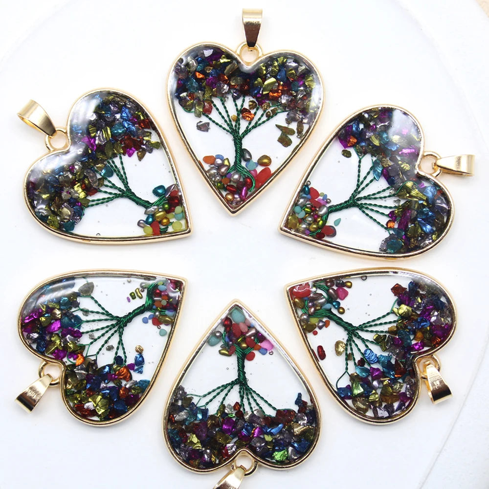 Set of heart-shaped pendants with colorful tree design on a white background