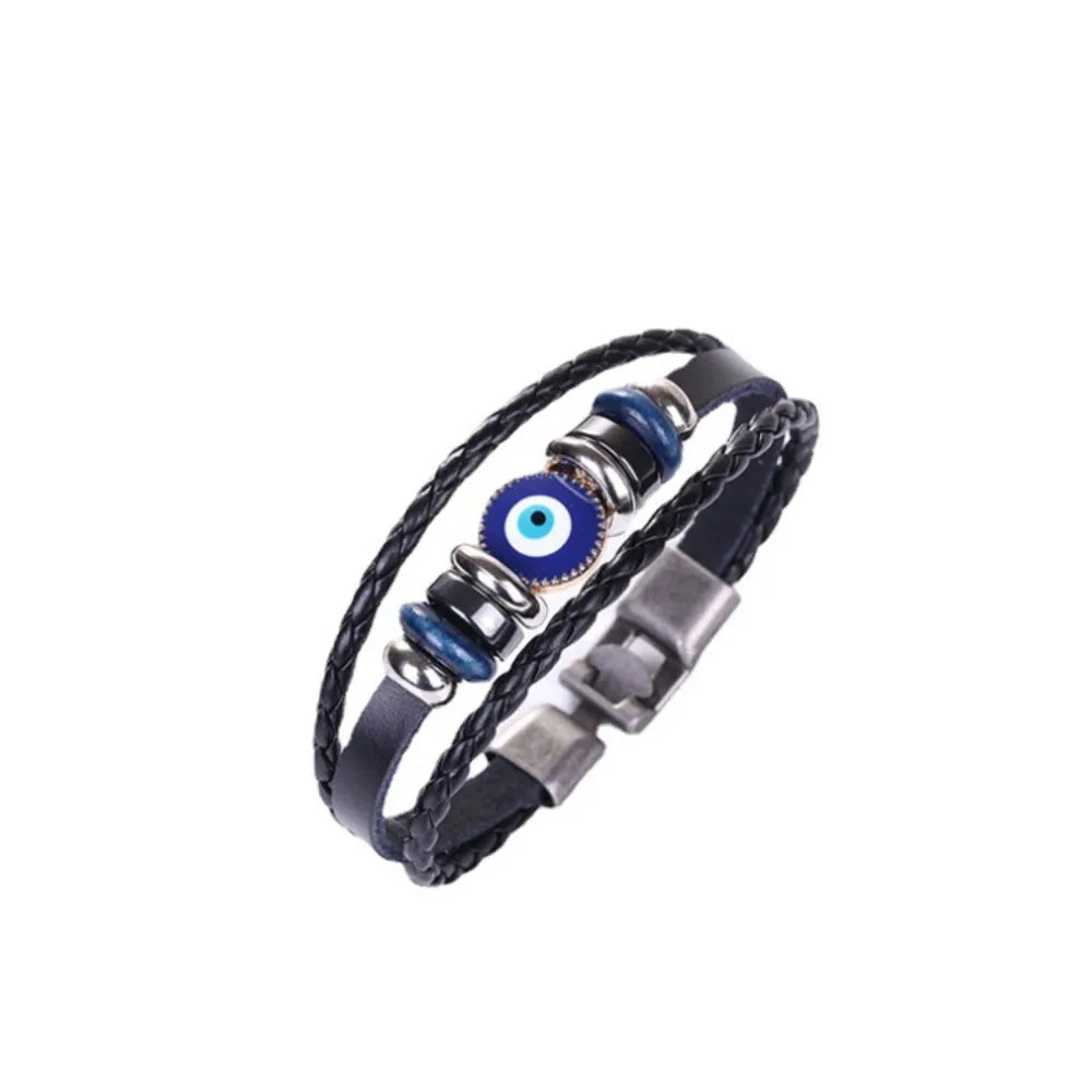 Black leather bracelet with blue evil eye charm on a white background