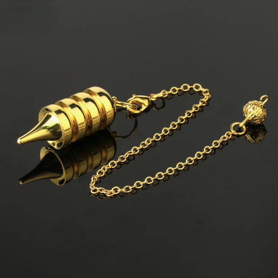 Gold-colored pen nib with chain on a black background