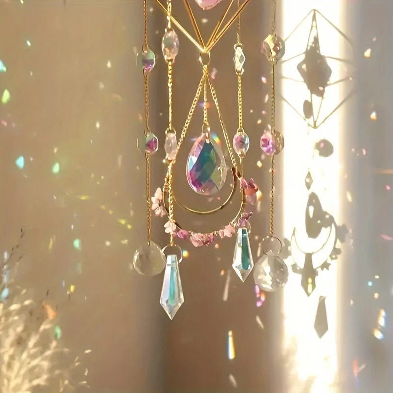 Decorative hanging crystal with colorful beads and gold chains against a light background