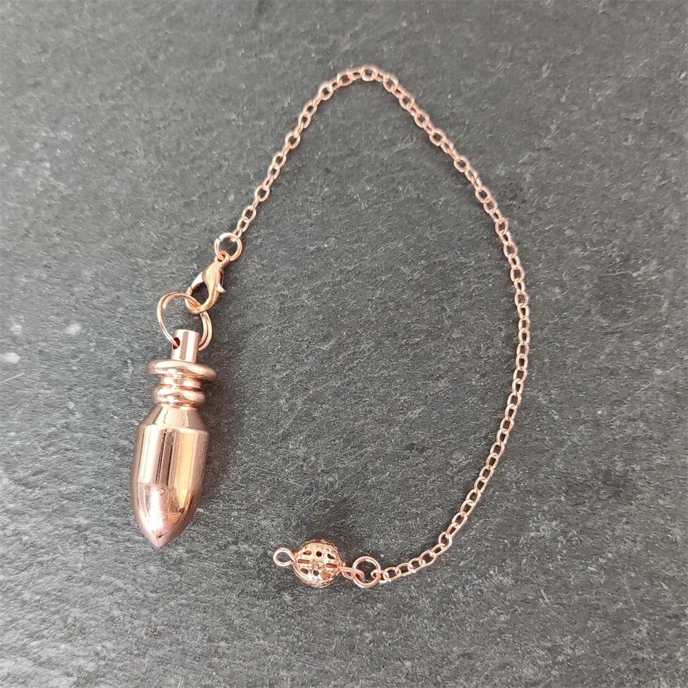 Rose gold chain with a small pendant on a gray surface