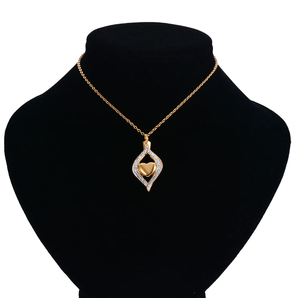 Gold necklace with a heart-shaped pendant on a black mannequin bust.