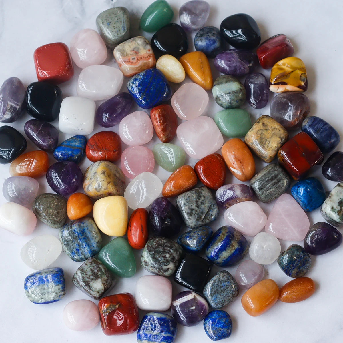 Assorted colorful gemstones on a white background