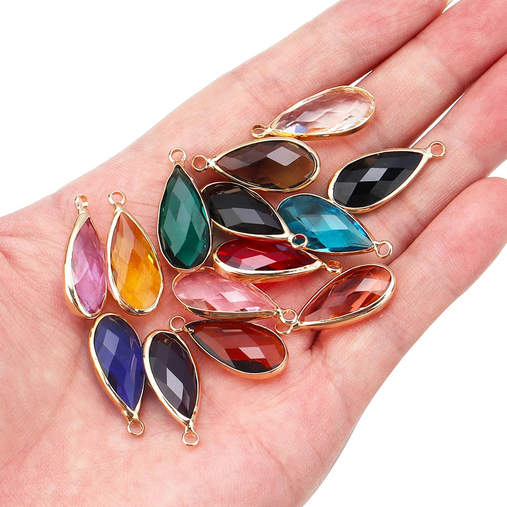 Colorful teardrop-shaped gemstones on a hand