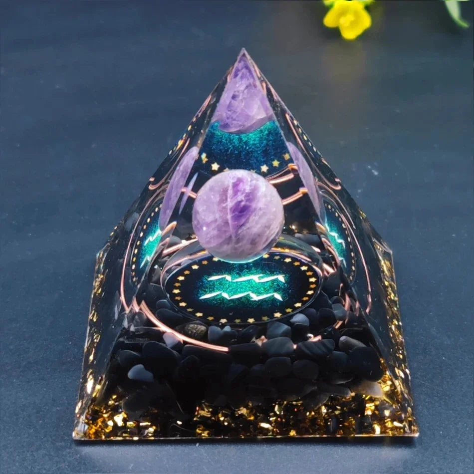 Decorative crystal pyramid with purple sphere and star design on a dark background