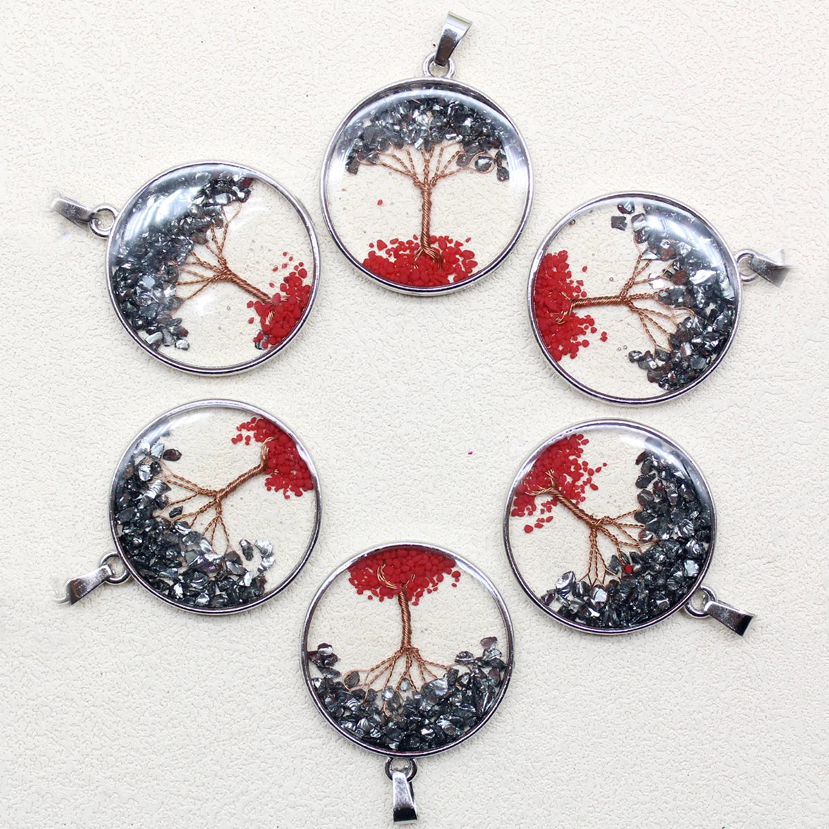 Set of six circular pendants with tree designs on a white background