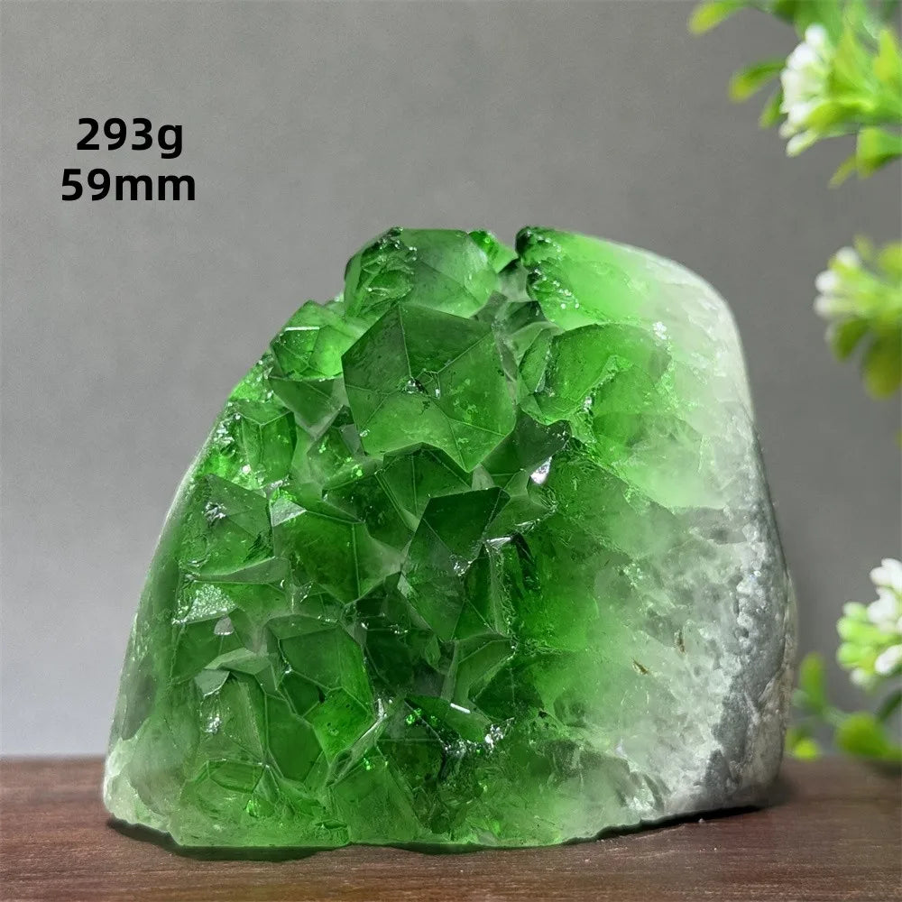 Green crystal rock on a wooden surface with a gray background