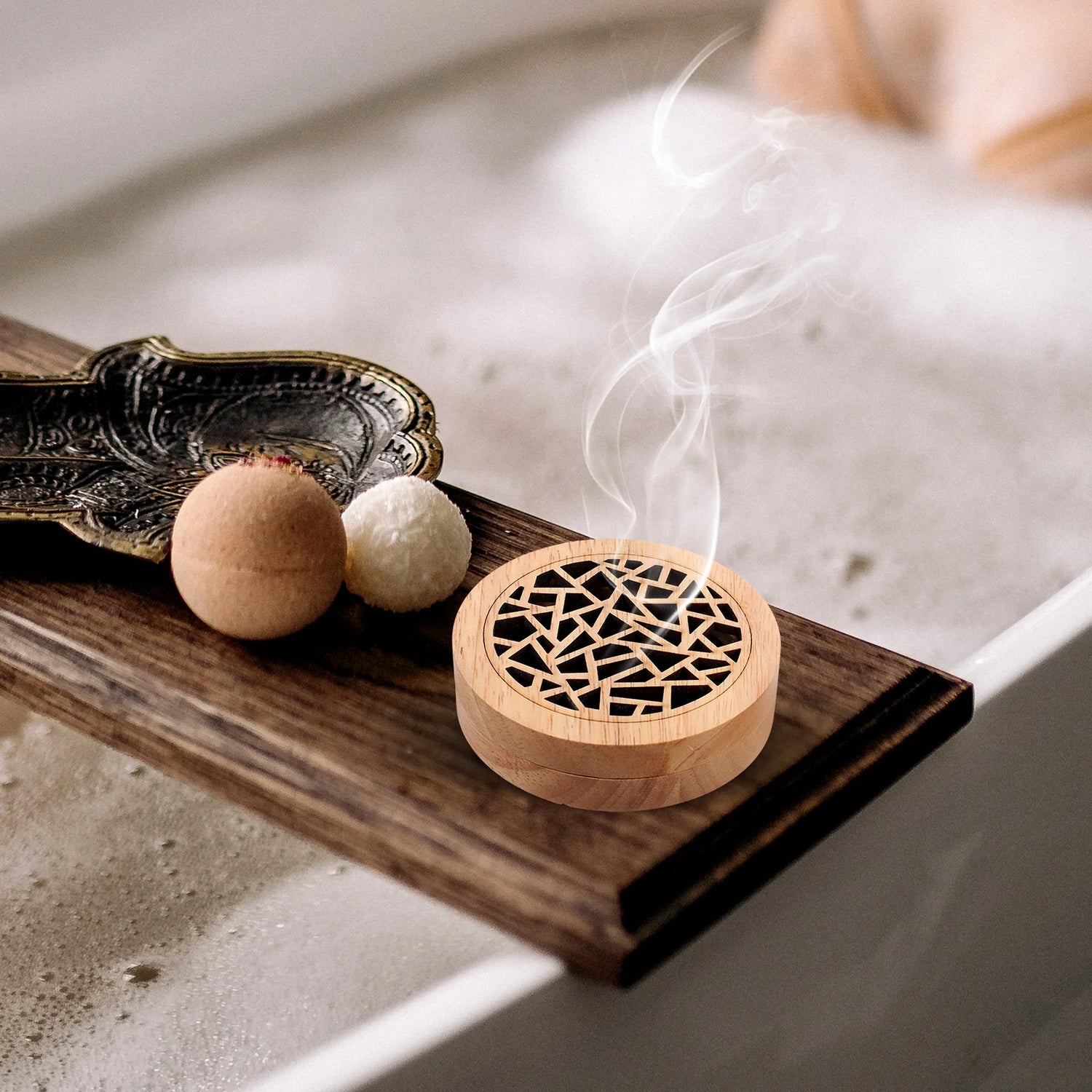 Wooden incense burner with smoke on a wooden tray over a bathtub.