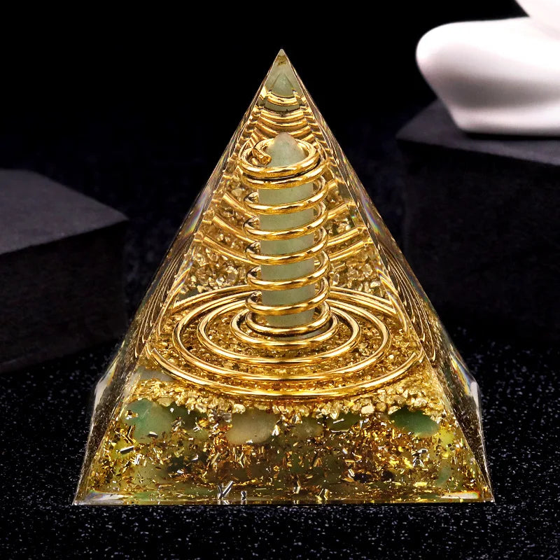 Pyramid-shaped object with gold and green elements on a black background