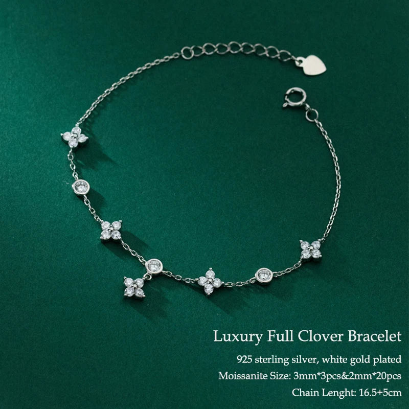 Silver bracelet with clover-shaped charms on a green background