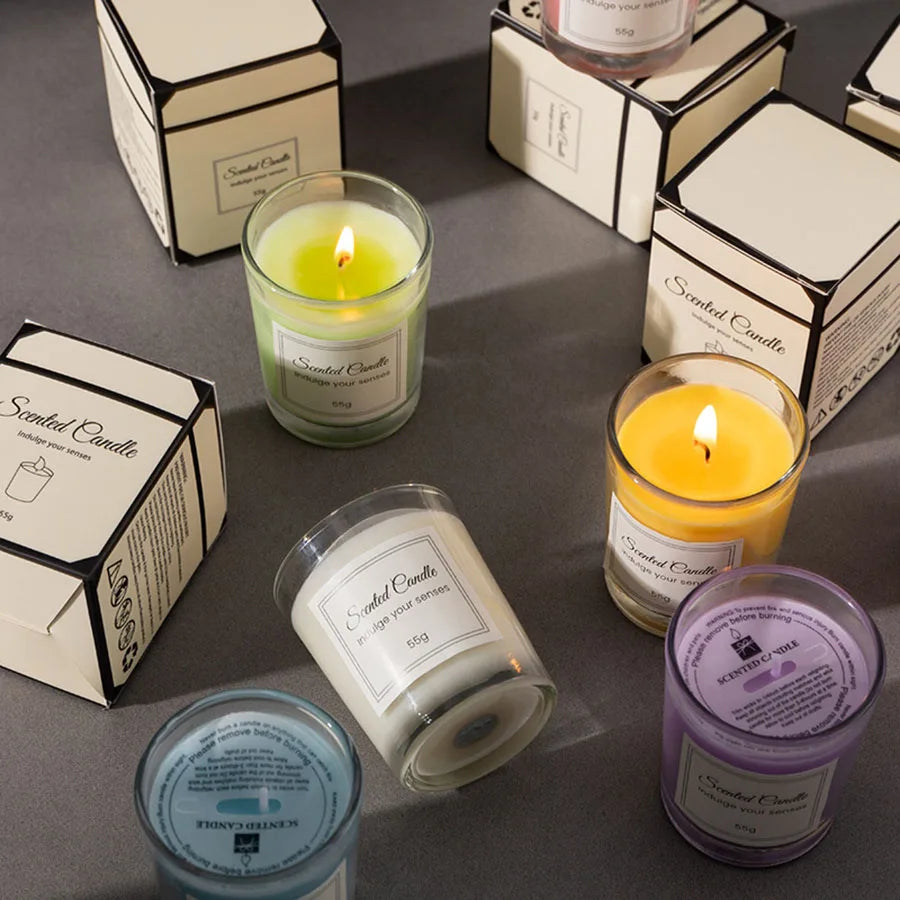 Collection of scented candles with labels on a gray surface
