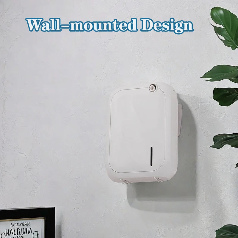 White wall-mounted device on a light gray wall with green leaves partially visible