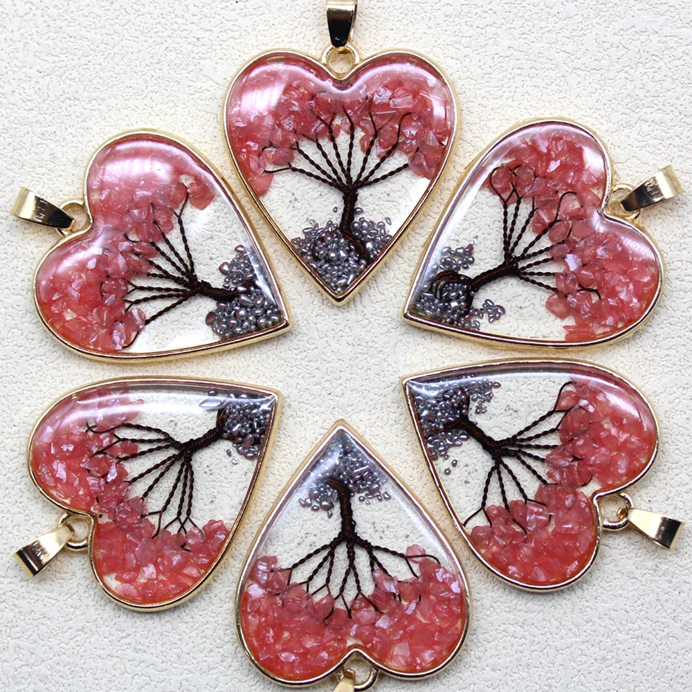 Set of heart-shaped pendants with cherry blossom design on a light background