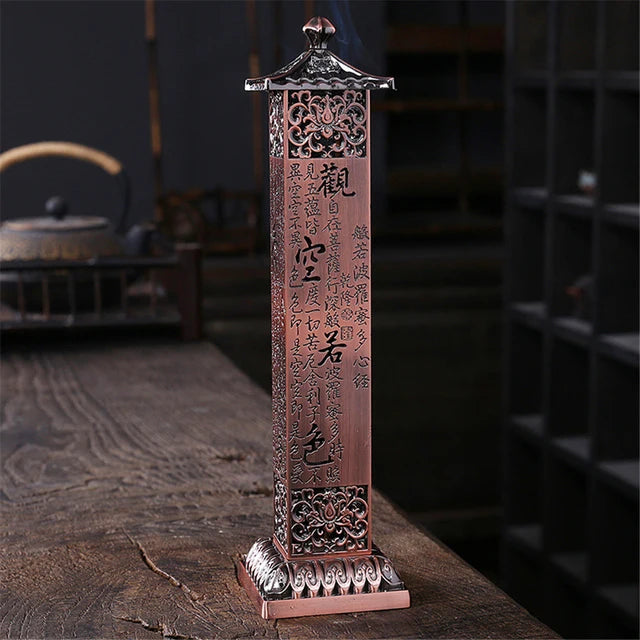 Decorative incense holder with Chinese characters on a wooden surface
