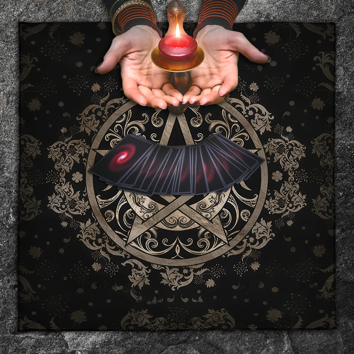 Hands holding a small lamp over an ornate circular design with a red eye-like symbol on a dark background.