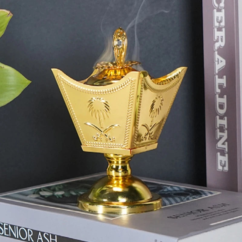 Gold incense burner with smoke on a book