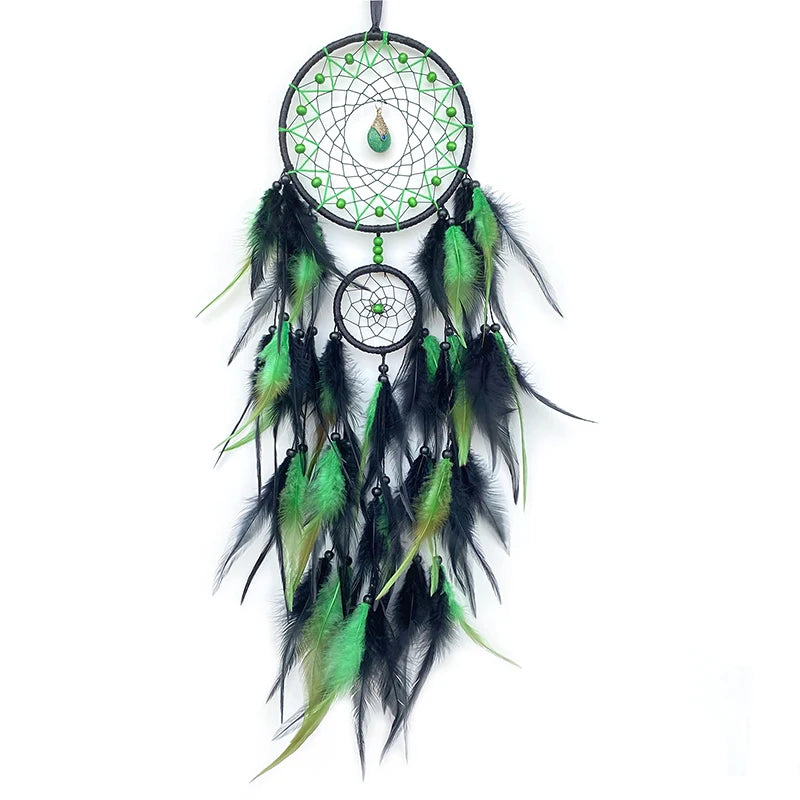 Green and black dreamcatcher with feathers on a white background