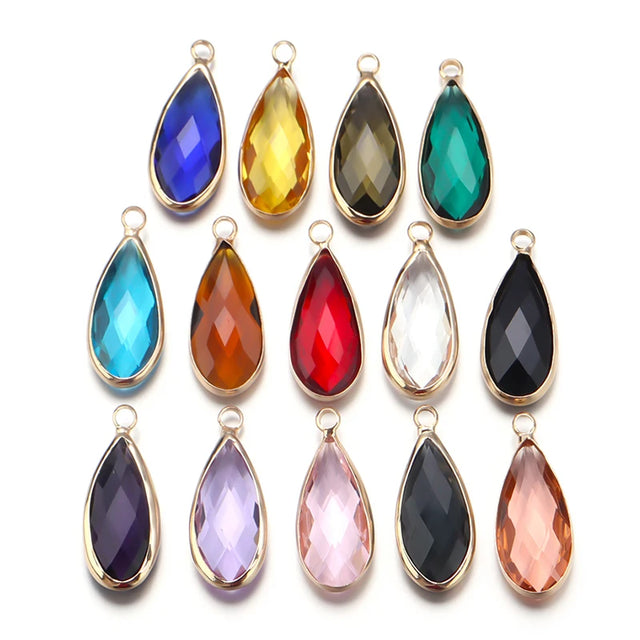 Set of colorful teardrop-shaped jewelry pendants on a white background