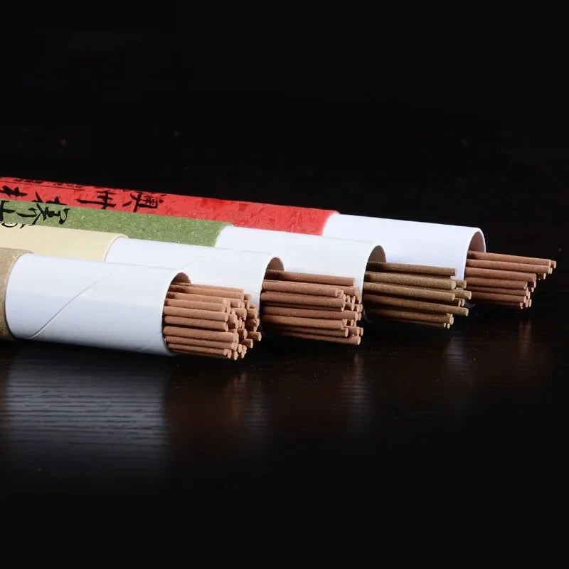 Set of bamboo skewers in white paper sleeves on a dark surface