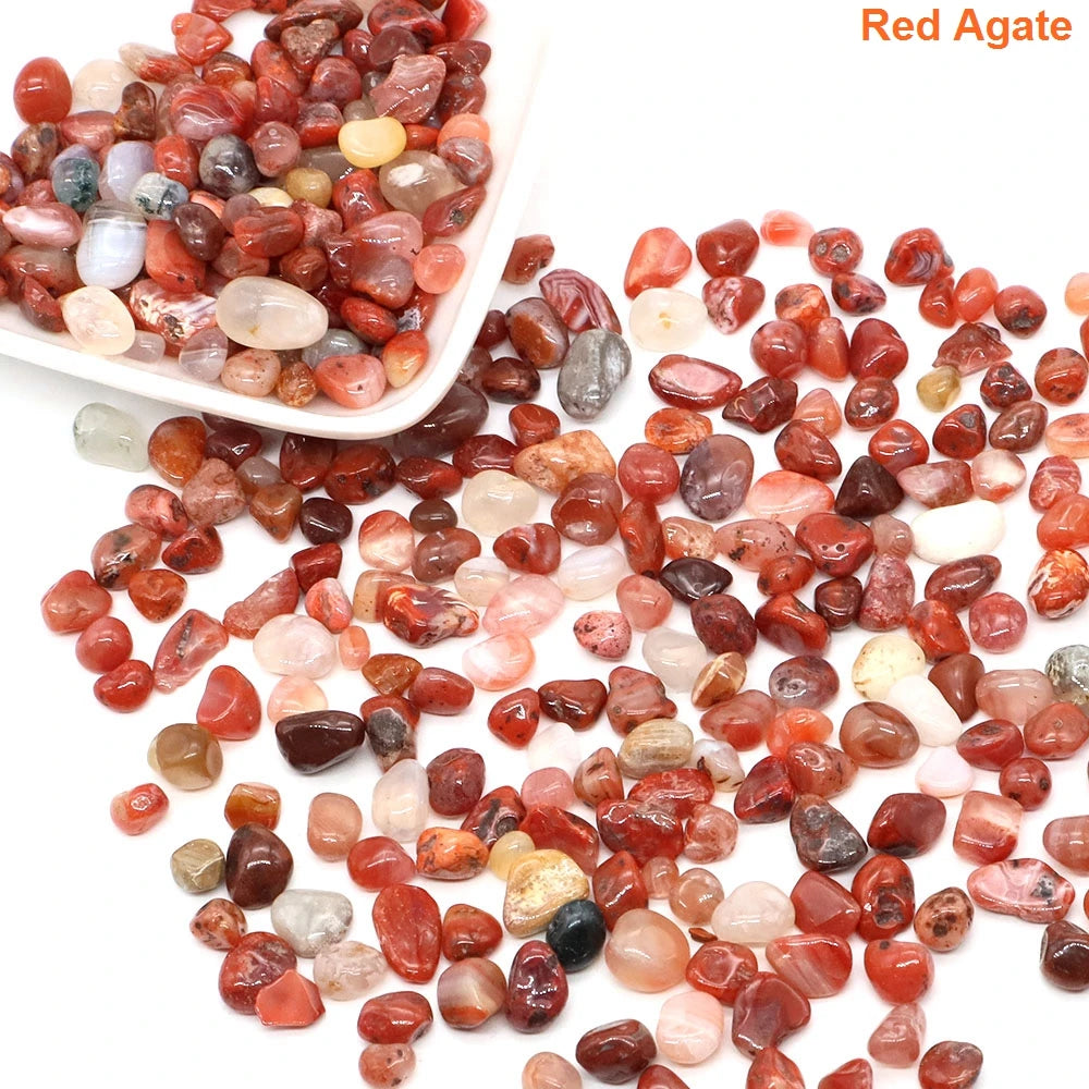Red agate stones with a white scoop on a white background