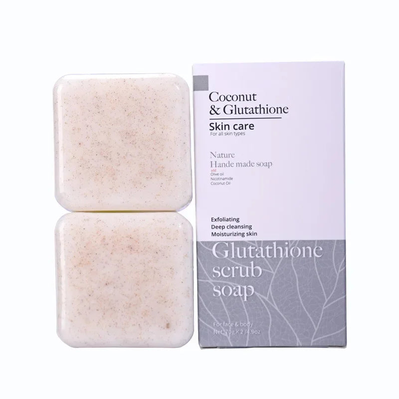 Two bars of coconut and glutathione scrub soap with a packaging box on a white background