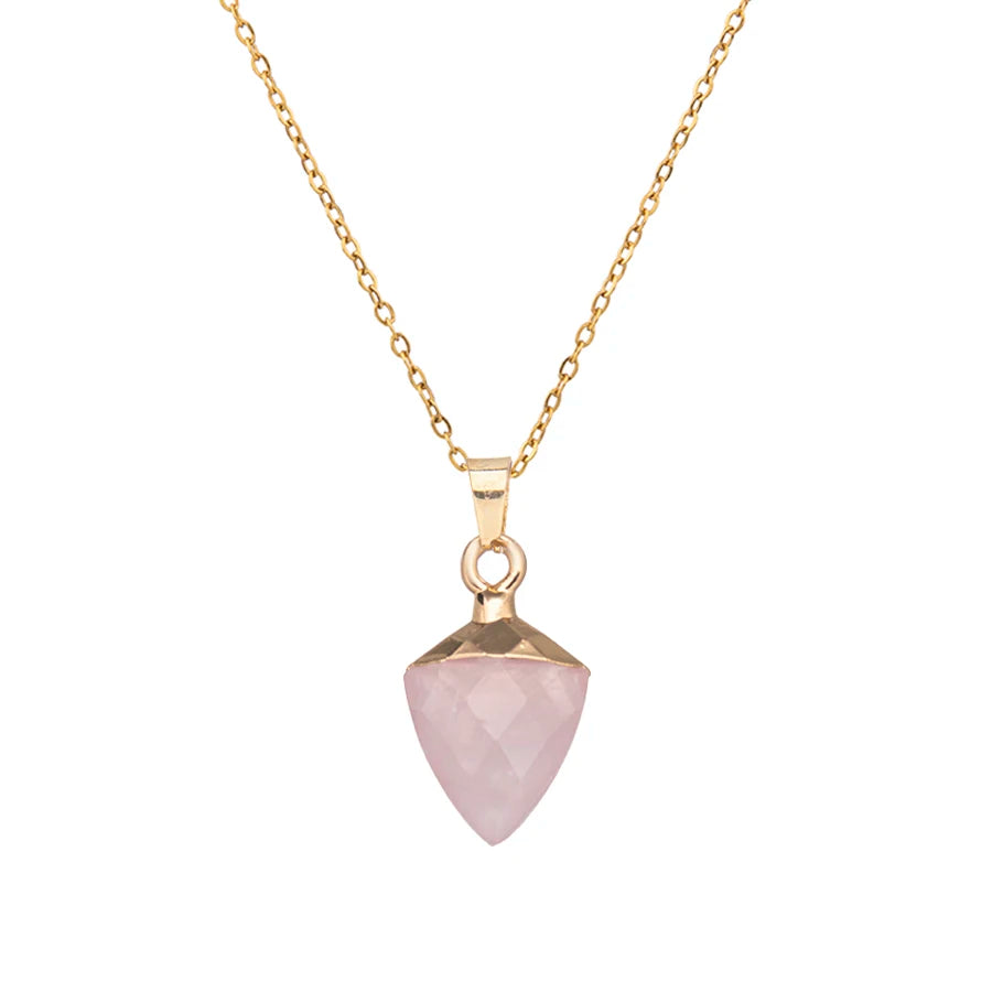 Necklace with a pink stone pendant on a gold chain against a white background