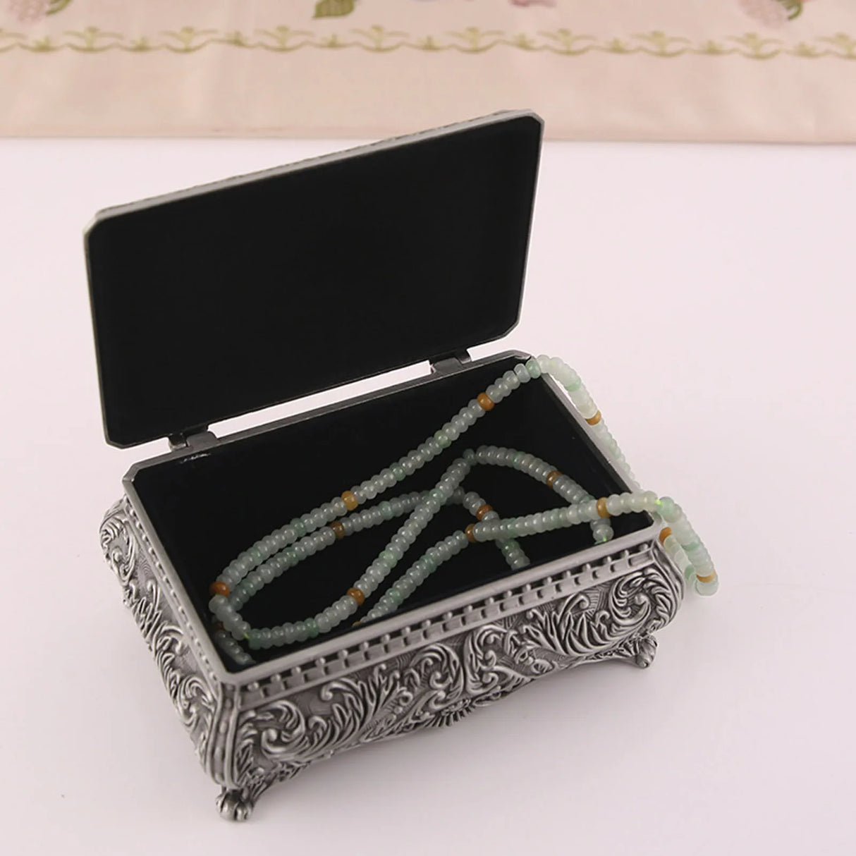 Decorative jewelry box with a necklace inside on a white background