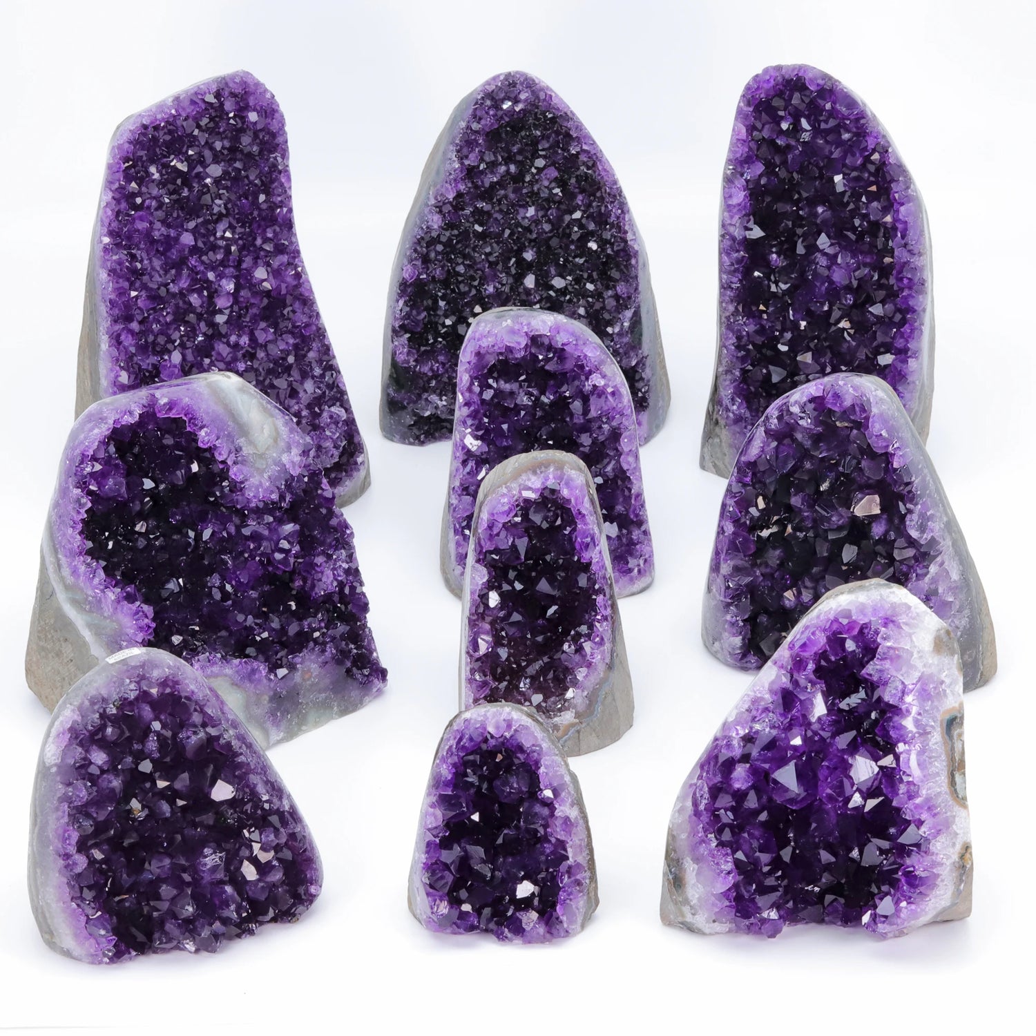 Collection of purple amethyst geodes on a white background