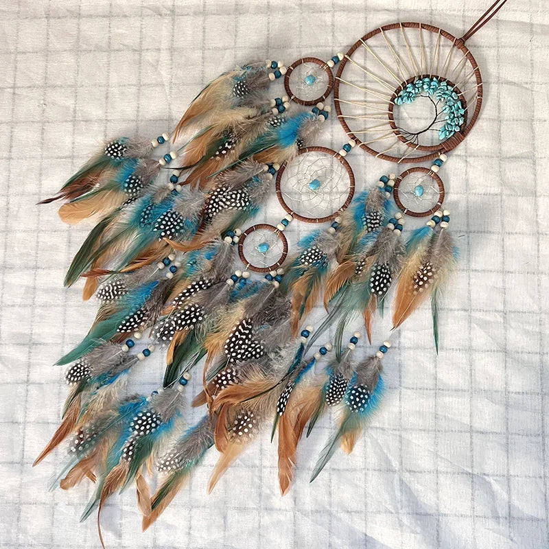 Decorative dreamcatcher with feathers and beads on a textured background
