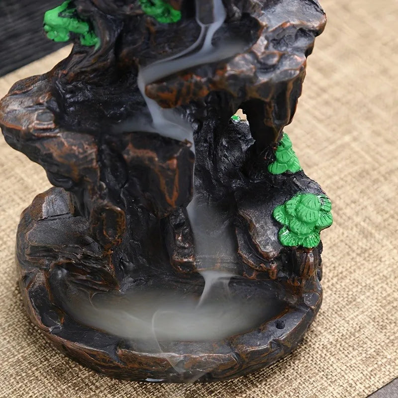 Decorative water fountain with rocks and greenery on a textured surface