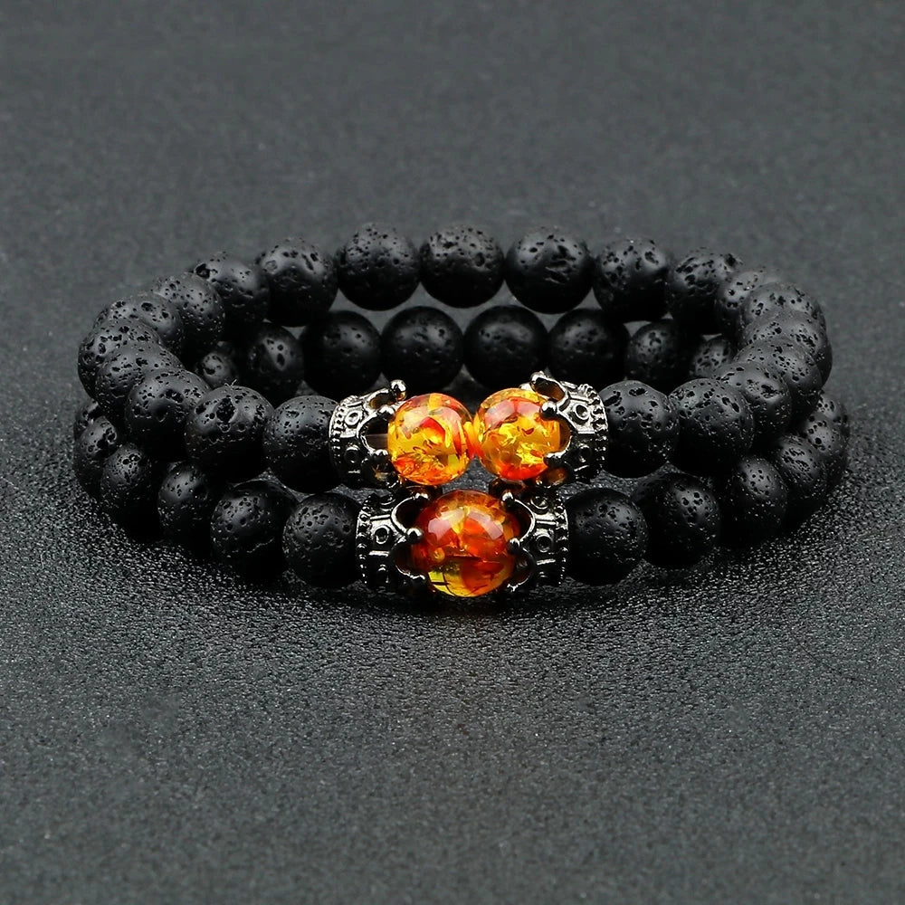 Black beaded bracelet with orange gemstones on a dark gray background