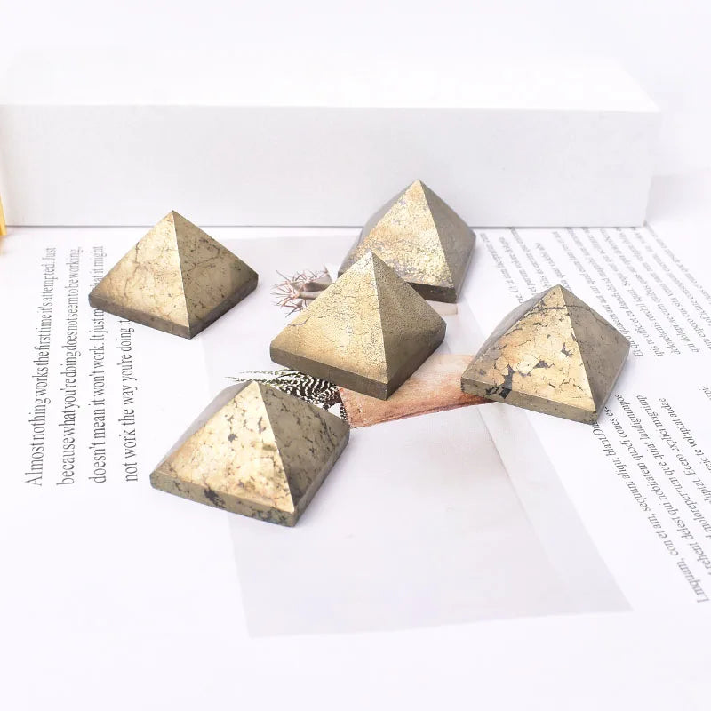 Pyramidal crystals on a white surface with text