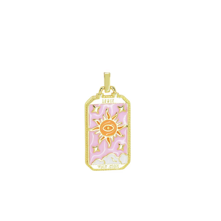 Gold pendant with pink and white design on a white background