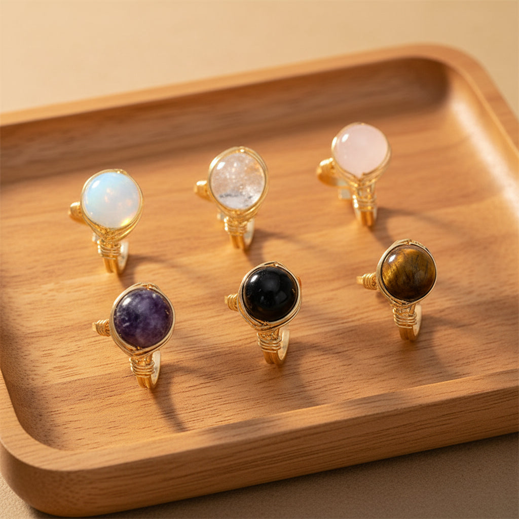 Set of six gold rings with different gemstones on a white background