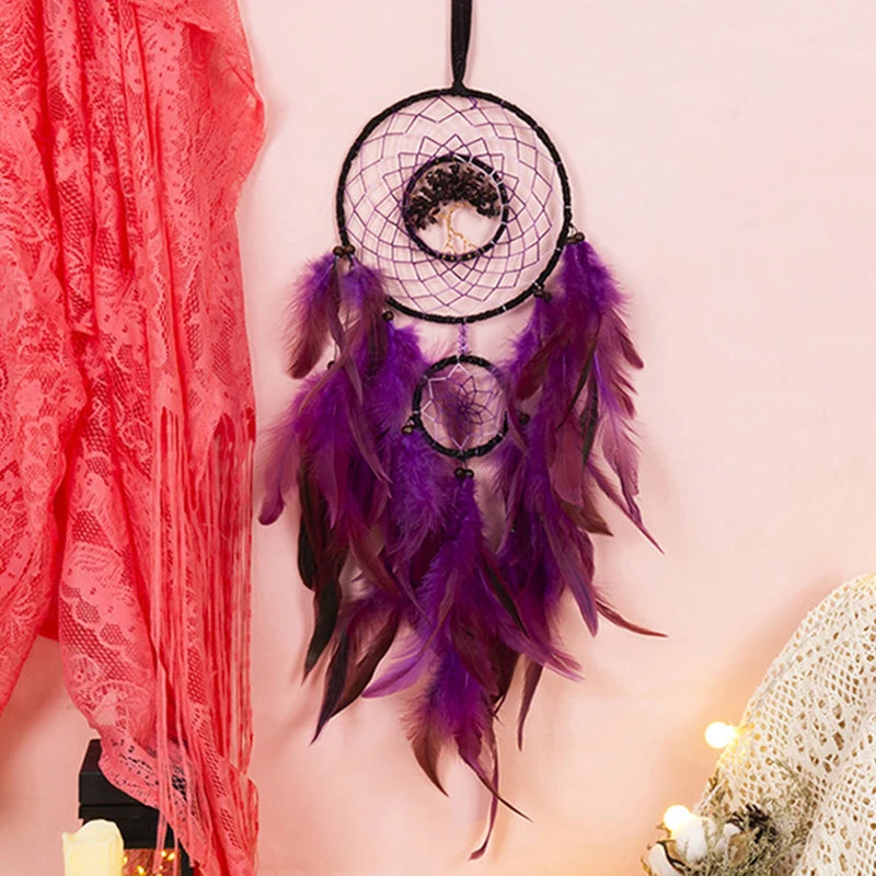 Purple dreamcatcher with feathers hanging on a person wearing a red lace garment.