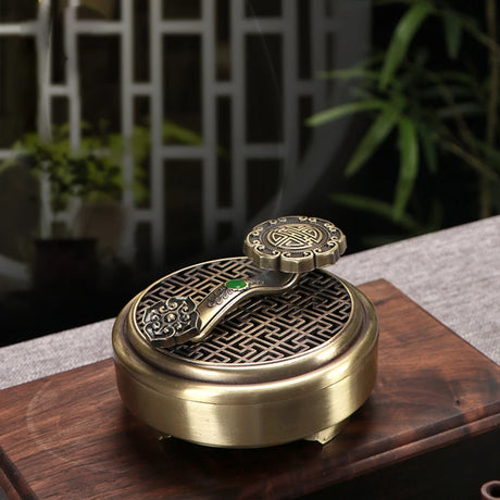 Decorative incense burner with intricate design on a wooden surface