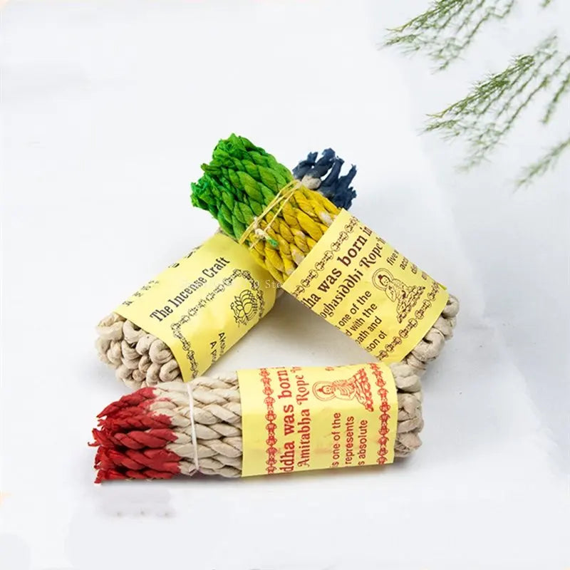 Three bundles of incense sticks with colorful labels on a white background